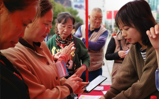 图为市民踊跃扫码关注药品安全。（蒙水 摄）.png