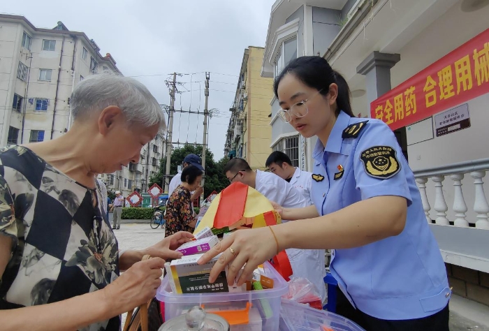 图为工作人员向社区咨询居民讲解药械安全知识。